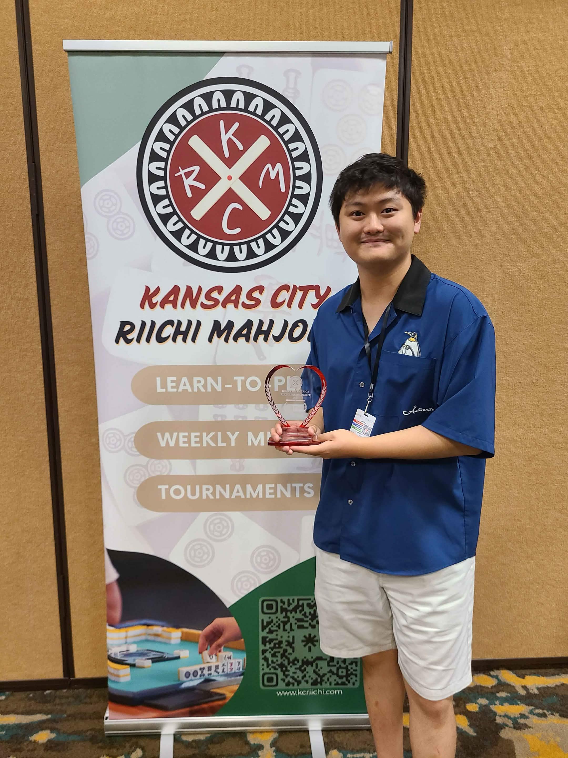 Edward Zeng holding a Kansas City Riichi Mahjong trophy